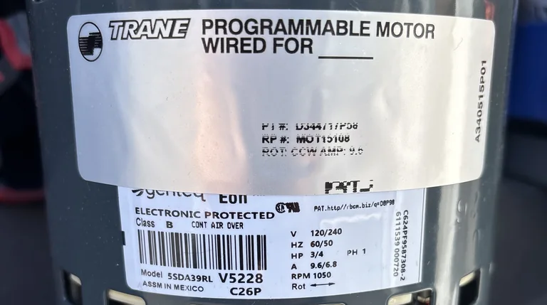 The Trane programmable blower motor from the Folsom job, its Genteq data plate showing 3/4 HP, 1050 RPM, 120/240 volts and 9.6/6.8 amps