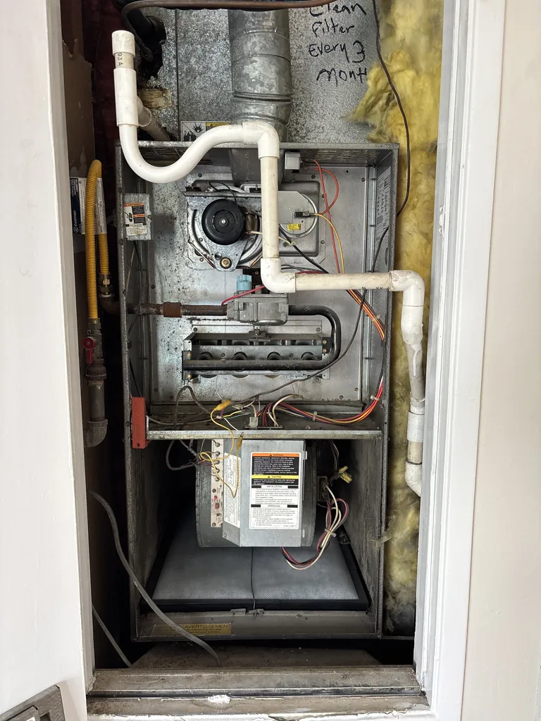 A gas furnace built in 1993 in a Citrus Heights closet, with its burner and blower doors off during a service call in March 2026
