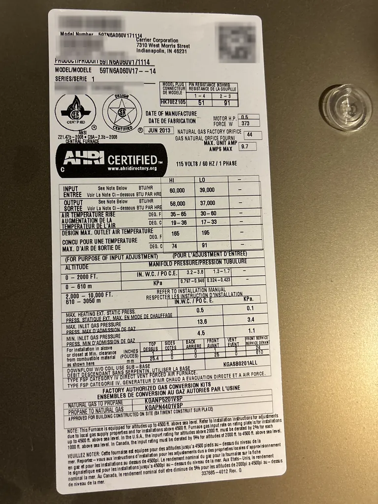 A gas furnace rating plate photographed on a Rancho Cordova service call: the model number at the top, the serial number blurred, and a date of manufacture box that reads JUN 2013