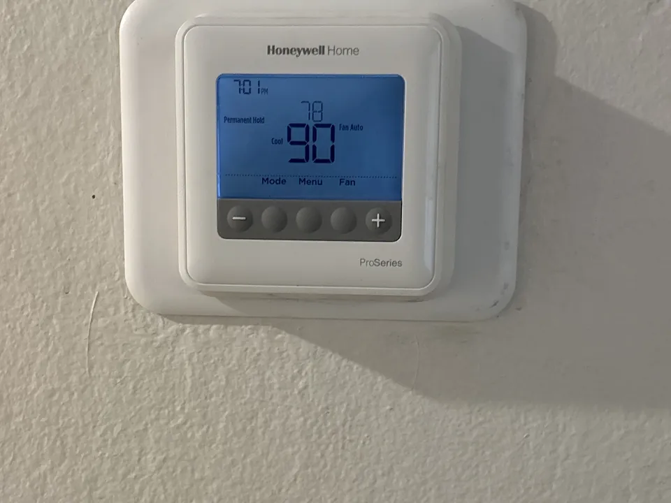 A Honeywell Home wall thermostat on an Alpha Mechanical service call in Sacramento in June 2026, still in Cool mode with the fan on Auto and a 78 degree setpoint; its Mode button is what switches it to Heat