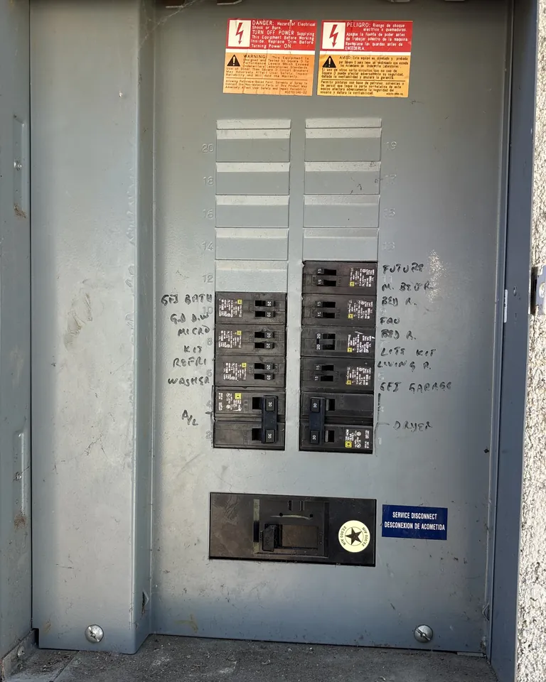 Alpha Mechanical job photo: an open outdoor electrical panel with hand-labeled breakers, a 30-amp two-pole breaker marked A/C on the lower row, and a column of open slots marked FUTURE above the loaded rows