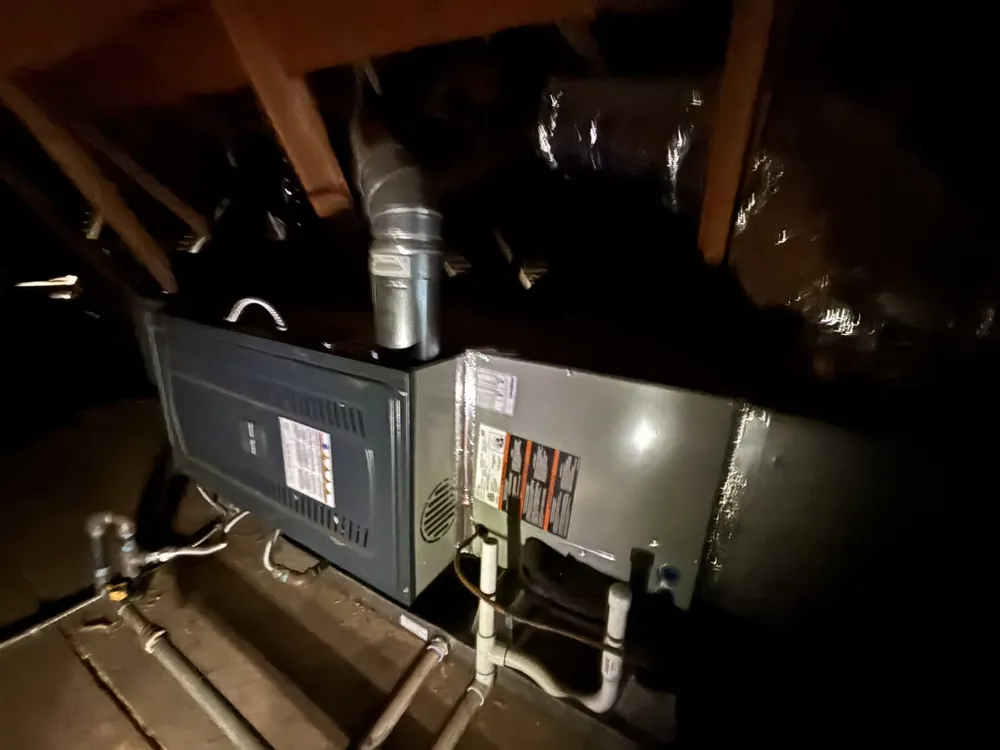 Horizontal gas furnace and coil cabinet with flue and condensate lines in a Folsom attic