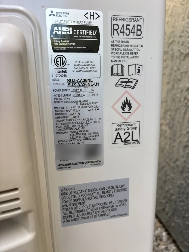 Rating plate on a Mitsubishi split-system heat pump showing R-454B refrigerant