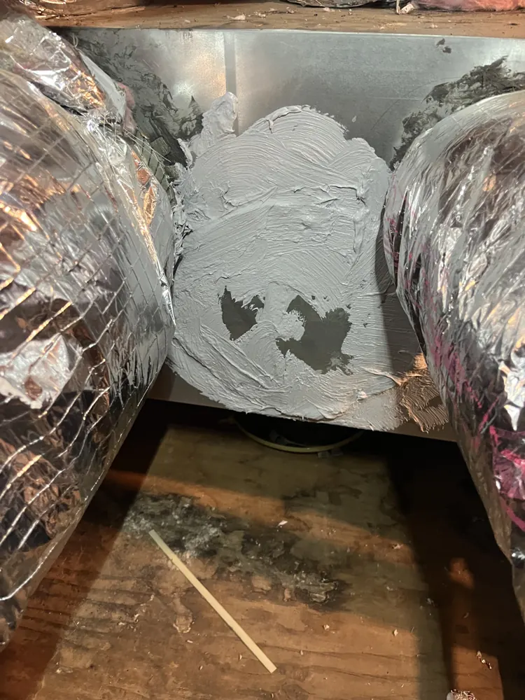 Fresh duct mastic sealing a plenum between two flex duct runs in a Gold River attic