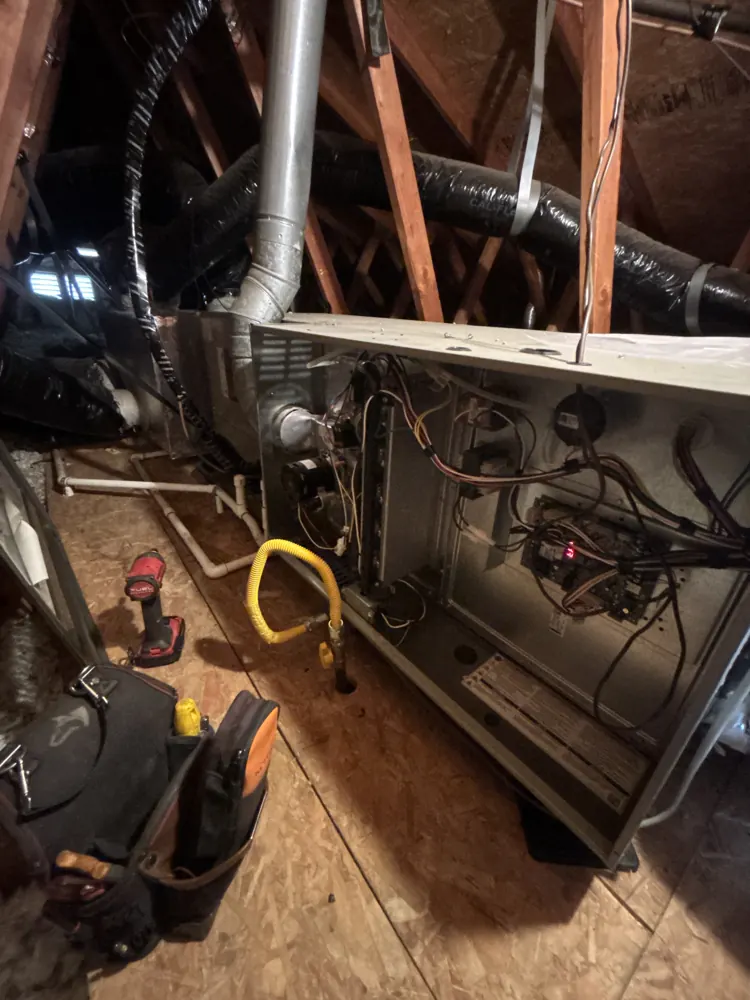 Control board and wiring inside an opened gas furnace in a Gold River attic