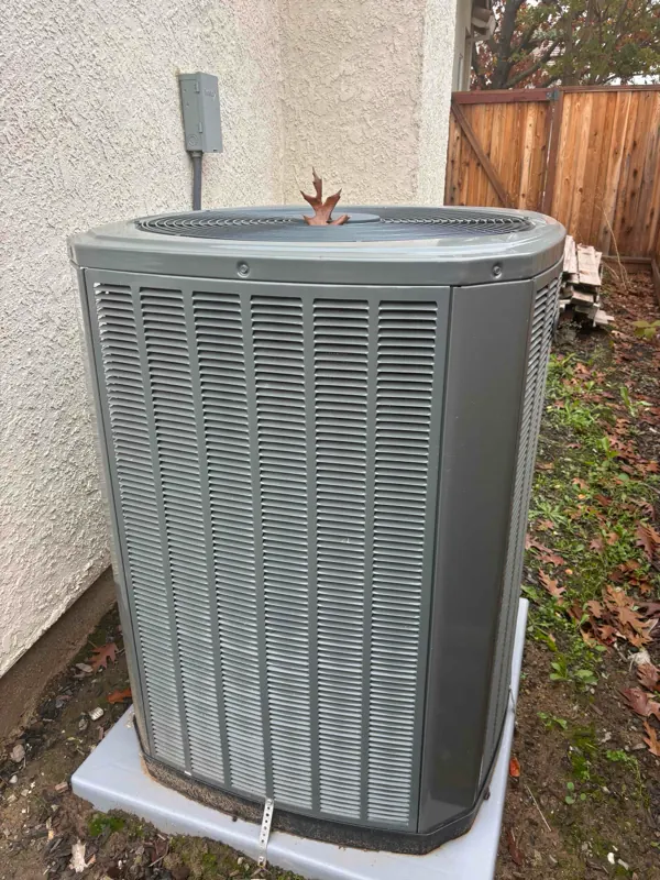New Trane condenser set on its pad beside a Roseville home