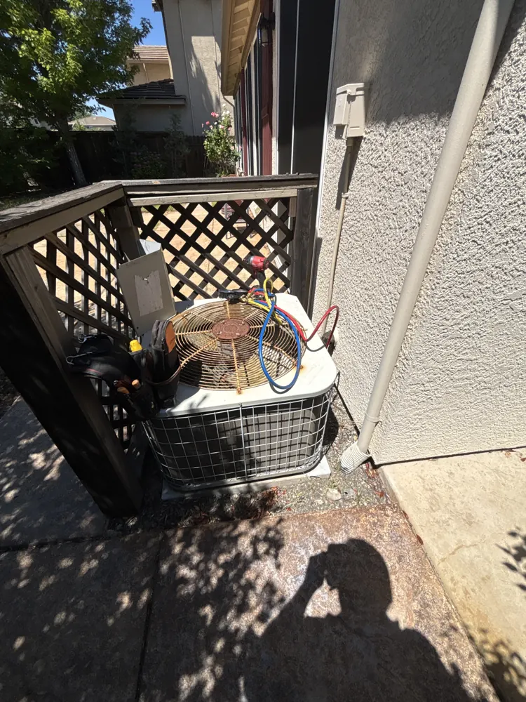Refrigerant gauges connected to a condenser in a Roseville side yard