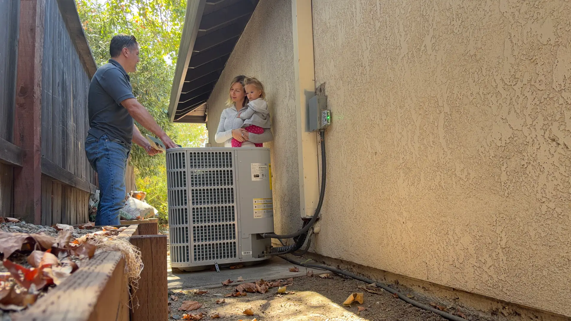 Alpha Mechanical technician going over a system replacement with a homeowner at a Sacramento-area home