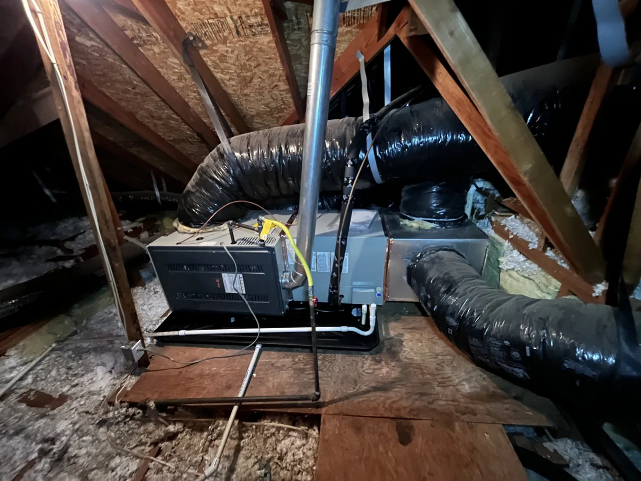 Newly installed attic air handler with a new sheet-metal plenum and flexible duct branches on an Alpha Mechanical Sacramento replacement