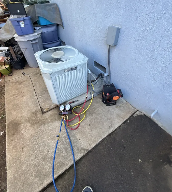 Alpha Mechanical manifold gauges connected to an aging residential R-22 condenser during a diagnostic visit in Sacramento