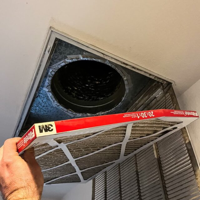Replacing a dirty pleated air filter at a ceiling return grille